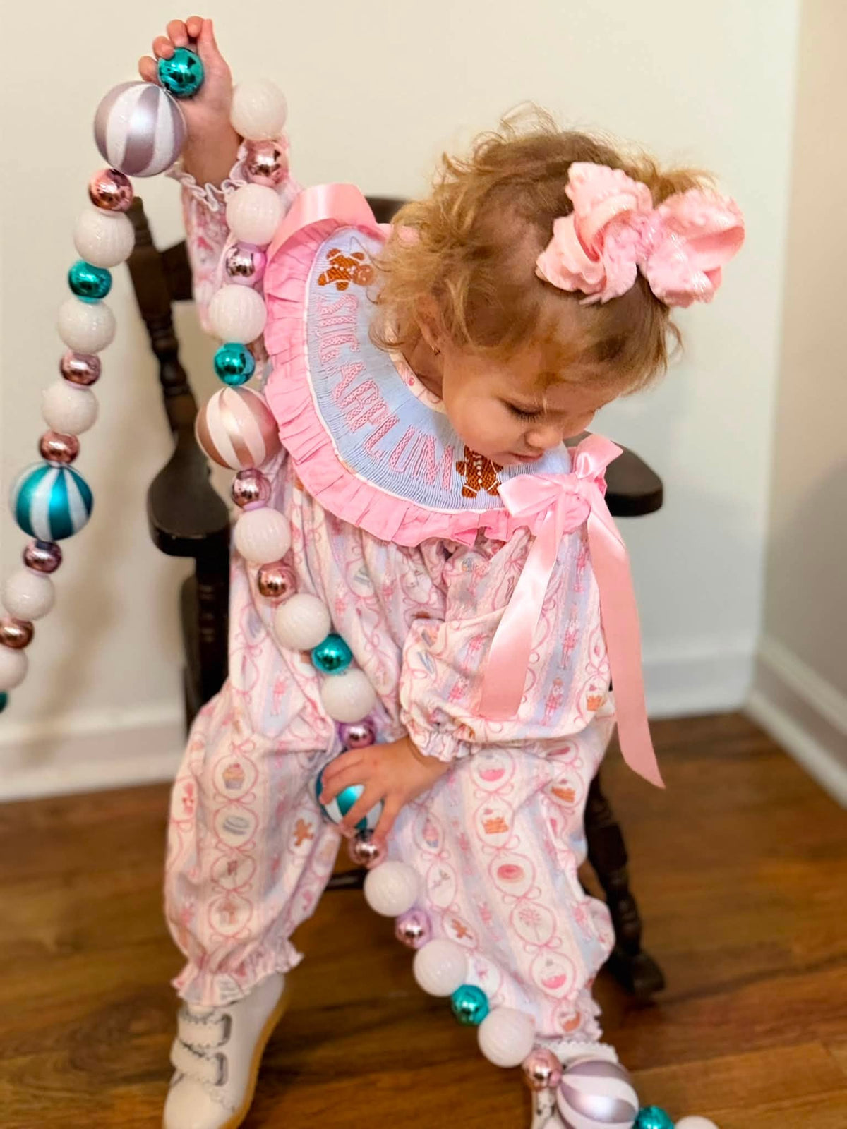 Hand-smocked Sugarplum Christmas romper with embroidered lettering