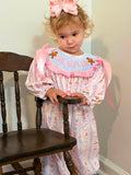 Girls smocked Christmas romper with pastel Nutcracker print and pink ruffles