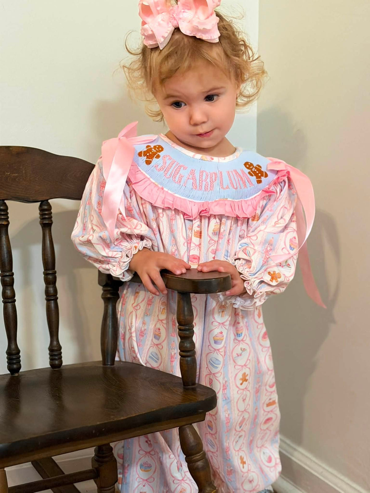 Girls smocked Christmas romper with pastel Nutcracker print and pink ruffles